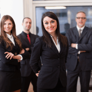 two women and two men from staffing agency in dark business suits smiling